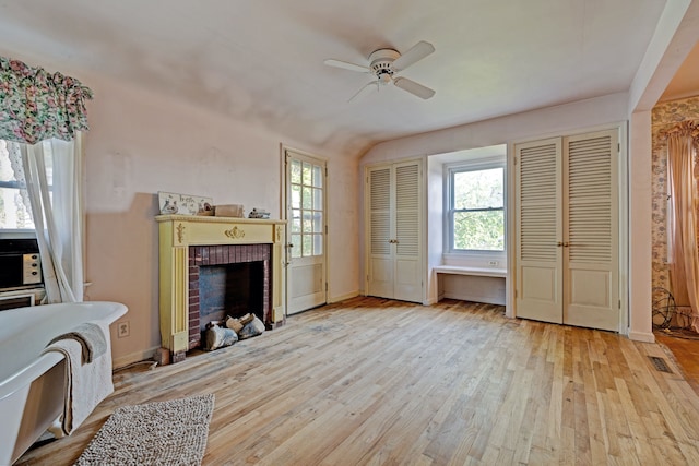 419 S State Rd, Davison, MI 48423 - unfurnished living room with hardwood / wood-style floors, a ceiling fan, plenty of natural light, a fireplace, and vaulted ceiling