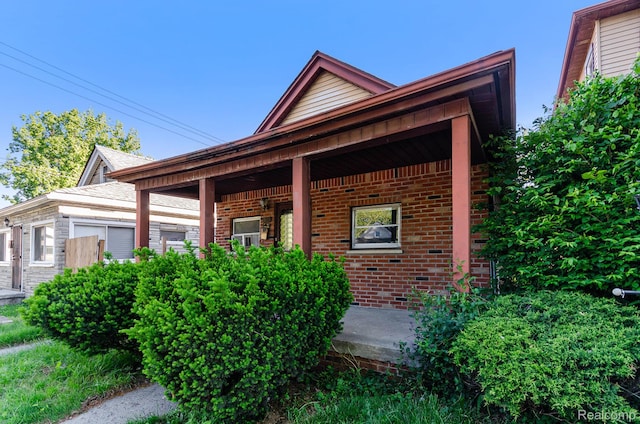 54 W Rockwood St, Ecorse, MI 48229 - view of front facade featuring brick siding and a porch