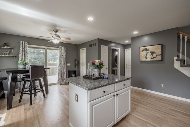 kitchen featuring a center island, a ceiling fan, light wood-type flooring, baseboards, and recessed lighting