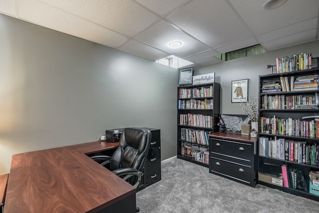 home office with carpet floors and a paneled ceiling