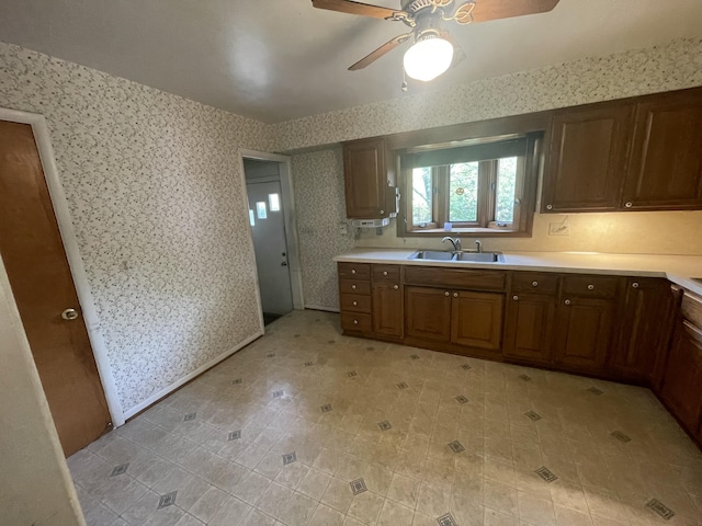 950 Raymond St, Ann Arbor, MI 48103 - kitchen with wallpapered walls, a ceiling fan, a sink, and light countertops