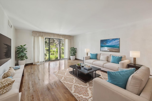 living area with wood finished floors and baseboards