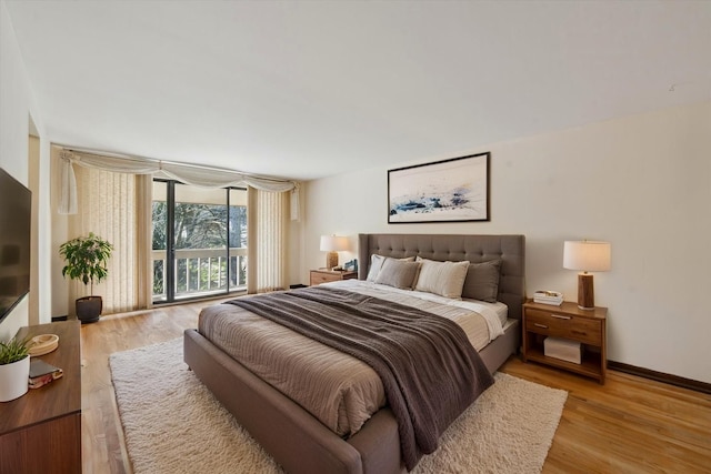 bedroom featuring light wood-type flooring and baseboards