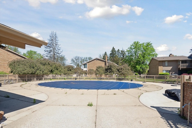 view of pool with fence and a patio