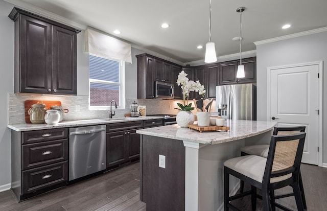 50279 Cromwell St, Canton, MI 48188 - kitchen with stainless steel appliances, a sink, ornamental molding, dark brown cabinetry, and decorative backsplash