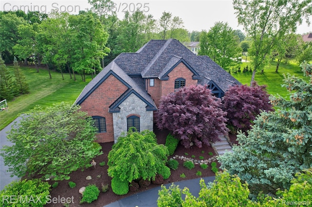 8320 Misty Mdws, Grand Blanc, MI 48439 - view of front facade featuring stone siding, a front yard, and brick siding