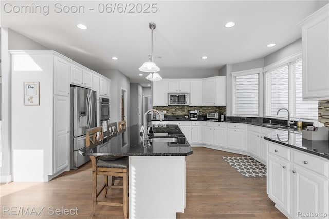 8320 Misty Mdws, Grand Blanc, MI 48439 - kitchen with stainless steel appliances, a sink, recessed lighting, tasteful backsplash, and a kitchen bar