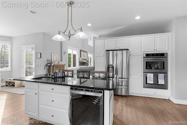 8320 Misty Mdws, Grand Blanc, MI 48439 - kitchen featuring wine cooler, stainless steel appliances, a sink, light wood finished floors, and recessed lighting