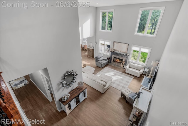 8320 Misty Mdws, Grand Blanc, MI 48439 - living area featuring a towering ceiling, wood finished floors, and a high end fireplace