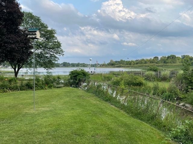 1090 Sunset Dr, Holly, MI 48442 - view of green lawn featuring a water view