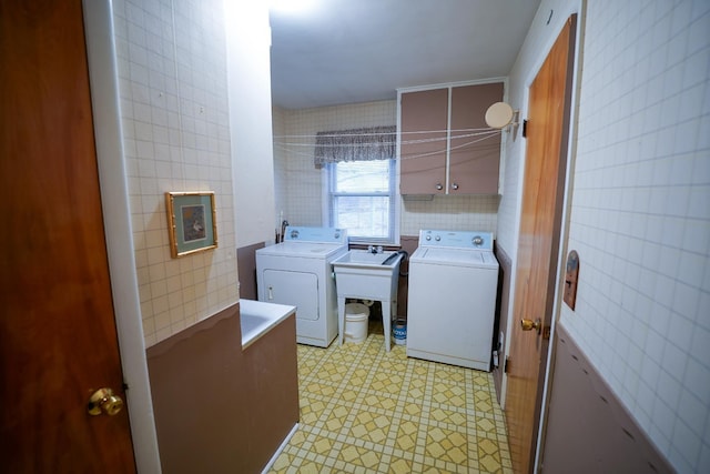1090 Sunset Dr, Holly, MI 48442 - washroom with tile walls and separate washer and dryer