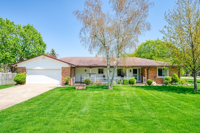 3683 Elmwood, Vassar, MI 48768 - single story home with a porch, an attached garage, driveway, and brick siding
