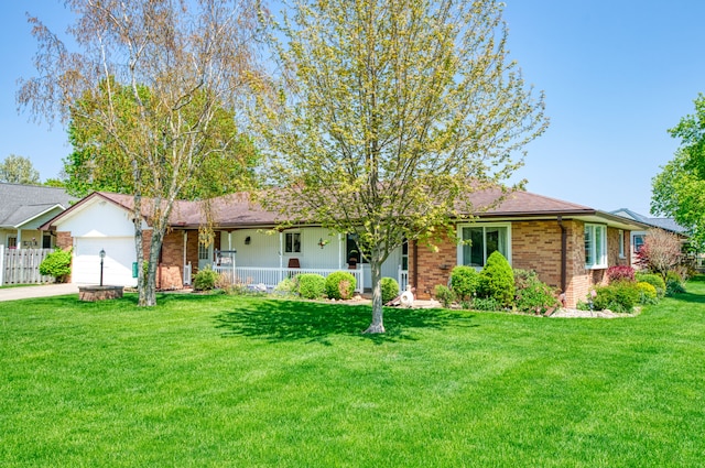 3683 Elmwood, Vassar, MI 48768 - single story home featuring covered porch, an attached garage, concrete driveway, and brick siding