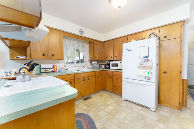 3683 Elmwood, Vassar, MI 48768 - kitchen with white appliances, light floors, light countertops, and brown cabinetry