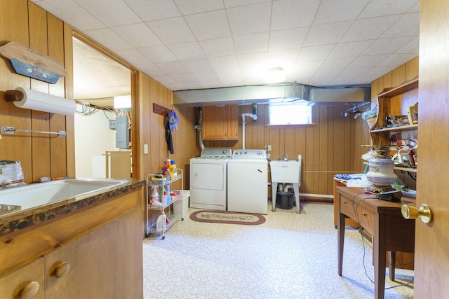 3683 Elmwood, Vassar, MI 48768 - laundry area featuring washing machine and clothes dryer, cabinet space, wooden walls, electric panel, and light flooring