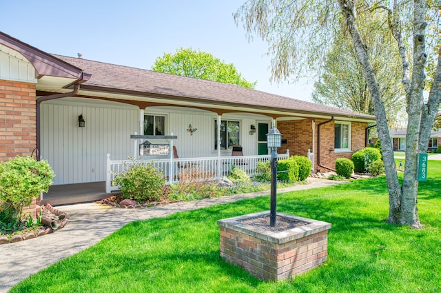 3683 Elmwood, Vassar, MI 48768 - single story home with a porch, a front yard, and brick siding