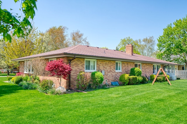 3683 Elmwood, Vassar, MI 48768 - rear view of property with a chimney, brick siding, and a yard