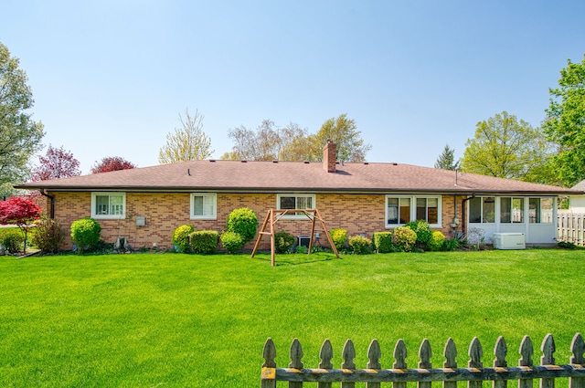3683 Elmwood, Vassar, MI 48768 - rear view of house with brick siding, a chimney, and a playground