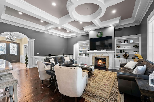 25031 Newton St, Dearborn, MI 48124 - living room featuring arched walkways, ornamental molding, ornate columns, beamed ceiling, and dark wood-style floors