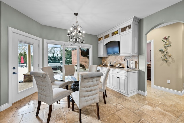 25031 Newton St, Dearborn, MI 48124 - dining space featuring stone tile floors, baseboards, and a chandelier