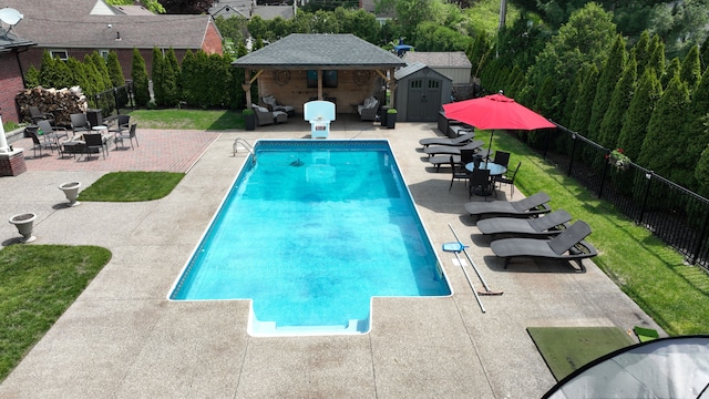 25031 Newton St, Dearborn, MI 48124 - view of swimming pool with an outdoor structure, a patio area, fence, a storage unit, and outdoor lounge area