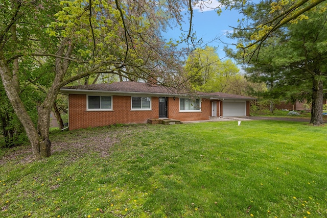 1090 S Williams Lake Rd, White Lake, MI 48386 - ranch-style house featuring an attached garage, brick siding, asphalt driveway, and a front yard