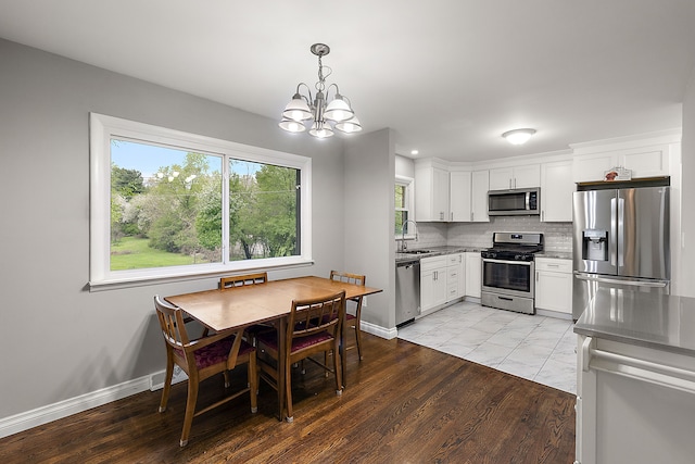 1090 S Williams Lake Rd, White Lake, MI 48386 - kitchen with stainless steel appliances, a sink, healthy amount of natural light, a chandelier, and recessed lighting