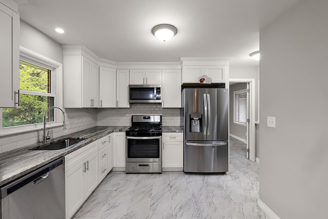 1090 S Williams Lake Rd, White Lake, MI 48386 - kitchen featuring stainless steel appliances, a sink, decorative backsplash, white cabinetry, and recessed lighting