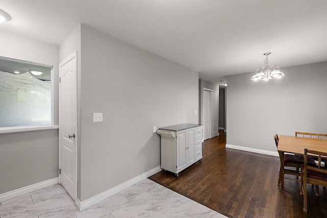 1090 S Williams Lake Rd, White Lake, MI 48386 - dining room with marble finish floors, a chandelier, and baseboards