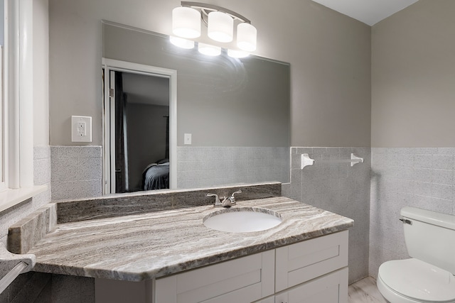 1090 S Williams Lake Rd, White Lake, MI 48386 - half bath featuring toilet, vanity, tile walls, and a wainscoted wall