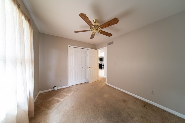 3142 Buss Dr, Commerce Twp, MI 48390 - unfurnished bedroom featuring light colored carpet, baseboards, a closet, and ceiling fan