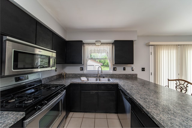 3142 Buss Dr, Commerce Twp, MI 48390 - kitchen with appliances with stainless steel finishes, dark cabinets, a sink, and dark countertops