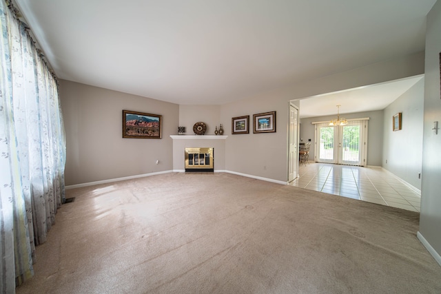 3142 Buss Dr, Commerce Twp, MI 48390 - unfurnished living room with a chandelier, a fireplace with flush hearth, carpet flooring, baseboards, and tile patterned floors