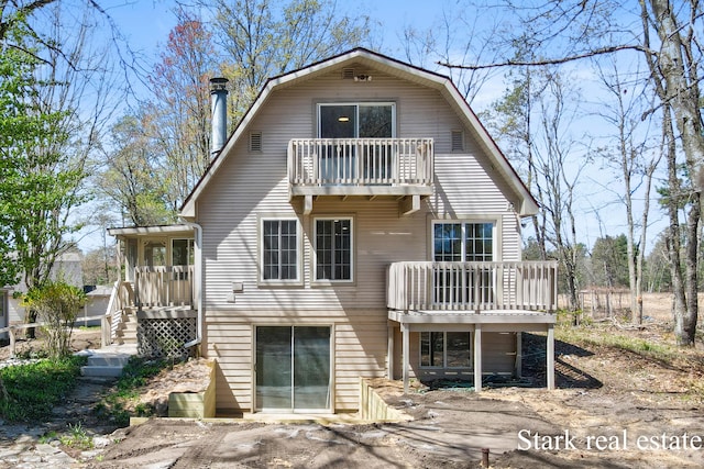 3339 N Weber Rd, Muskegon, MI 49445 - rear view of house featuring a balcony and a gambrel roof