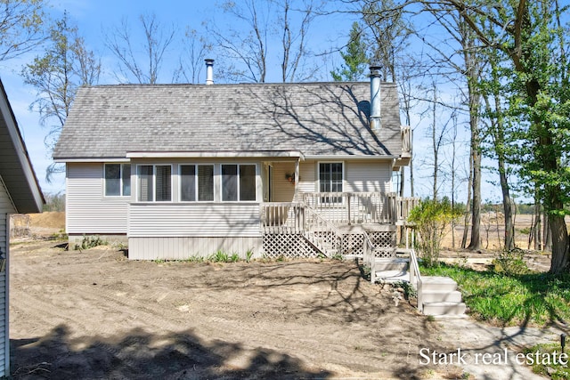 3339 N Weber Rd, Muskegon, MI 49445 - view of front facade with a chimney, roof with shingles, and a deck