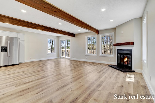 3339 N Weber Rd, Muskegon, MI 49445 - unfurnished living room with a glass covered fireplace, light wood-type flooring, recessed lighting, baseboards, and beamed ceiling