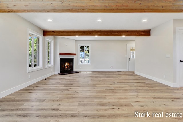 3339 N Weber Rd, Muskegon, MI 49445 - unfurnished living room featuring recessed lighting, beam ceiling, healthy amount of natural light, baseboards, and light wood finished floors