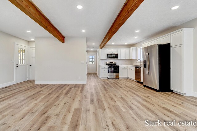 3339 N Weber Rd, Muskegon, MI 49445 - kitchen featuring stainless steel appliances, light wood finished floors, beamed ceiling, recessed lighting, and white cabinetry