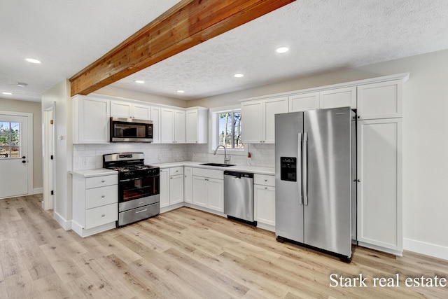 3339 N Weber Rd, Muskegon, MI 49445 - kitchen with stainless steel appliances, a sink, light wood-style flooring, recessed lighting, and tasteful backsplash