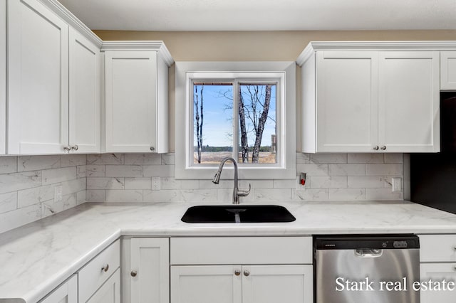 3339 N Weber Rd, Muskegon, MI 49445 - kitchen featuring stainless steel dishwasher, a sink, white cabinetry, and backsplash