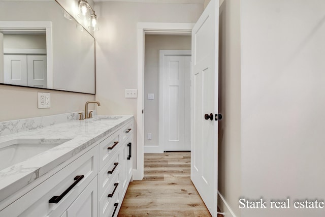 3339 N Weber Rd, Muskegon, MI 49445 - bathroom with wood finished floors and double vanity