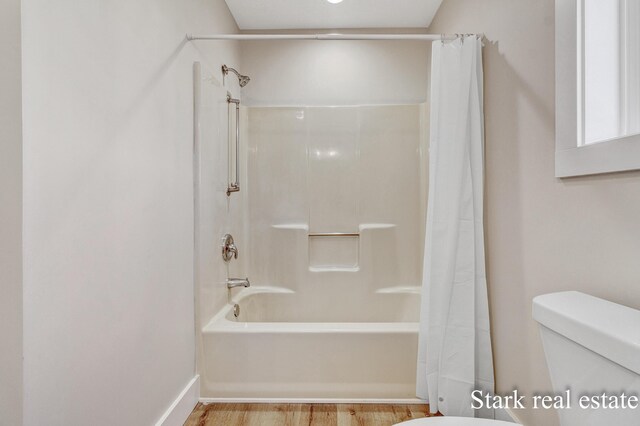 3339 N Weber Rd, Muskegon, MI 49445 - bathroom with toilet, shower / bathtub combination with curtain, and wood finished floors
