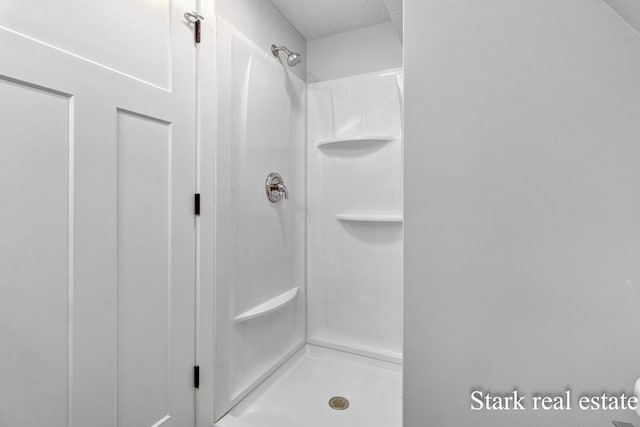 3339 N Weber Rd, Muskegon, MI 49445 - full bathroom featuring a shower stall and a textured ceiling