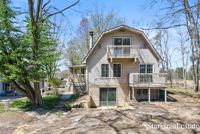 3339 N Weber Rd, Muskegon, MI 49445 - back of house featuring a balcony and a gambrel roof