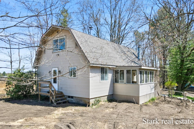 3339 N Weber Rd, Muskegon, MI 49445 - view of home's exterior featuring a sunroom and a shingled roof