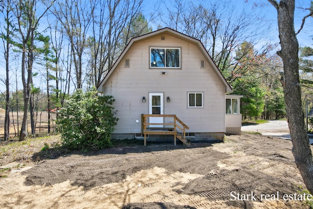 3339 N Weber Rd, Muskegon, MI 49445 - rear view of house featuring a gambrel roof and fence