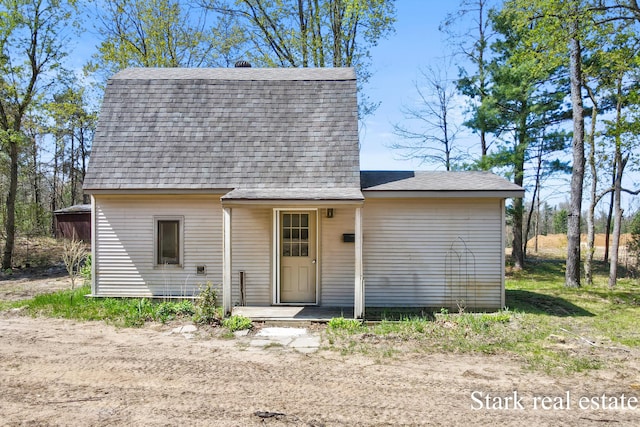 3339 N Weber Rd, Muskegon, MI 49445 - view of front of house featuring a shingled roof and a gambrel roof