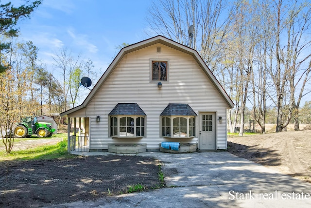 3339 N Weber Rd, Muskegon, MI 49445 - rear view of property featuring a gambrel roof and a shingled roof