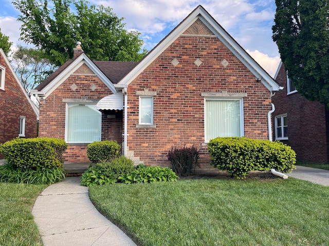 11520 Engleside St, Detroit, MI 48205 - view of front of home featuring a front yard, brick siding, and a chimney