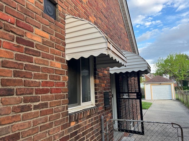 11520 Engleside St, Detroit, MI 48205 - view of side of home with brick siding, concrete driveway, an outdoor structure, and a garage